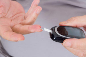 Diabetic patient testing his blood for sugar level