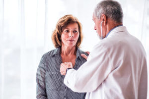 Internal Medicine Doctor examining a senior woman in his office