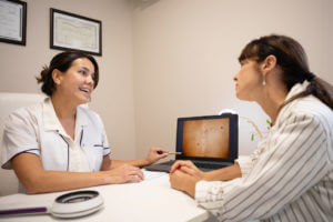 Dermatologist in consultation with female patient.