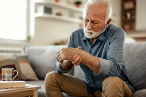 Elderly male patient suffer from numbing pain in hand due to Arthritis.
