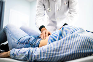 Image of a gastroenterologist examining a patient's abdomen for abdominal and irritable bowel syndrome (IBS).