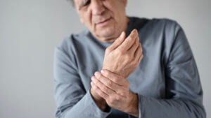 An old man suffering from arthritis pain and rheumatism.