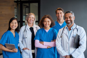 A portrait of a happy, smiling healthcare team of doctors looking at the camera.